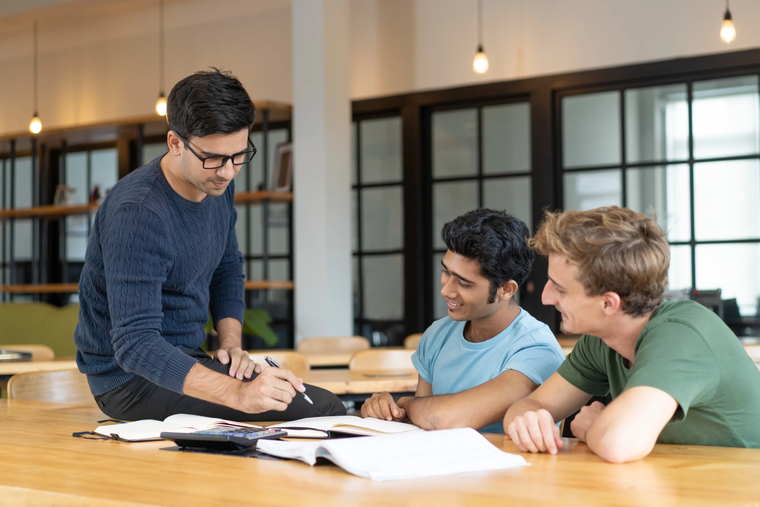 A Nepcoms adviser working through a scholarship application with a student